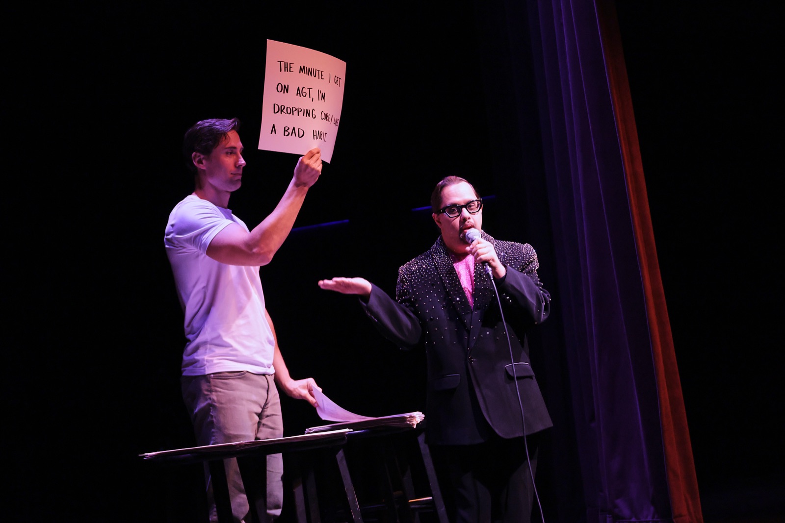 Corey Martin Craig holds up a cue card while Parth Bhatt performs on the UNDERDOG TOUR&trade;